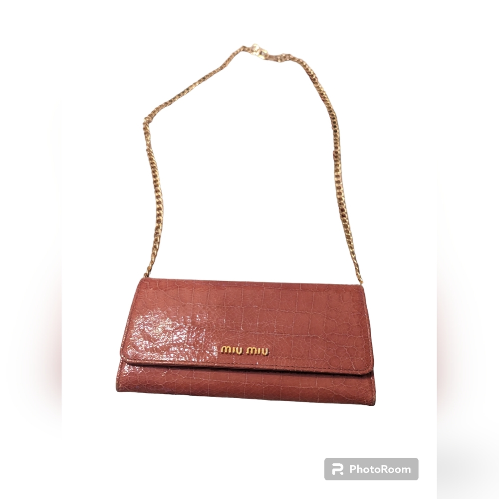 MIU MIU croc embossed long double snap wallet in pink.